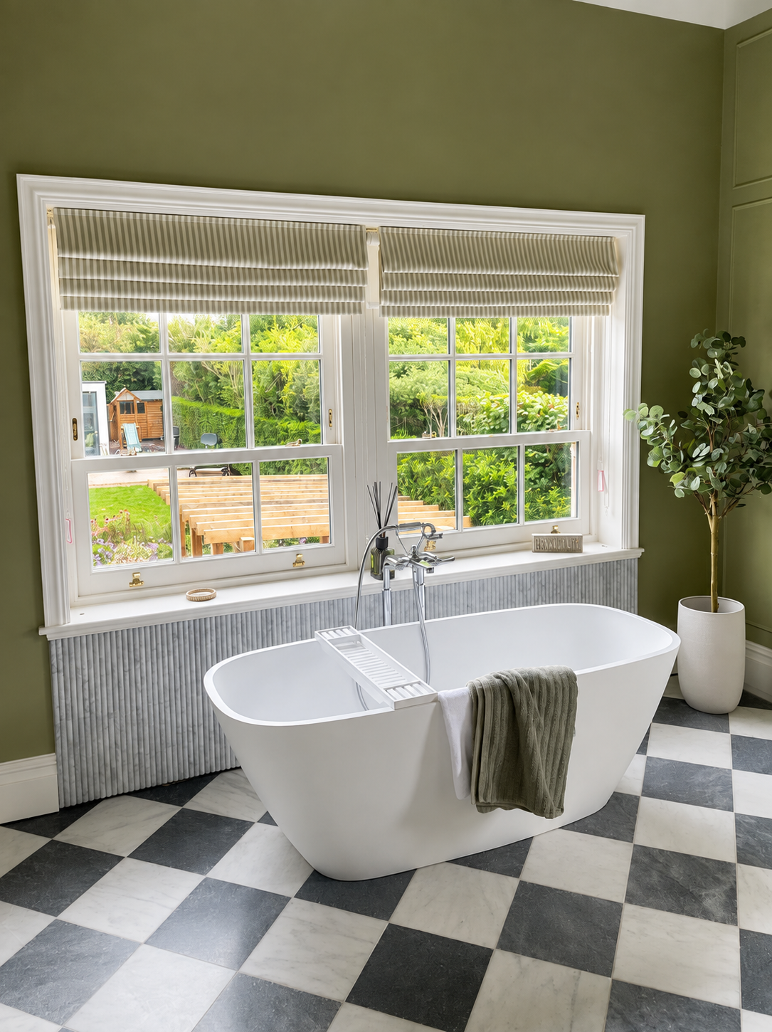 Offset double box sash windows with astragal bars and brass fittings in a green painted bathroom