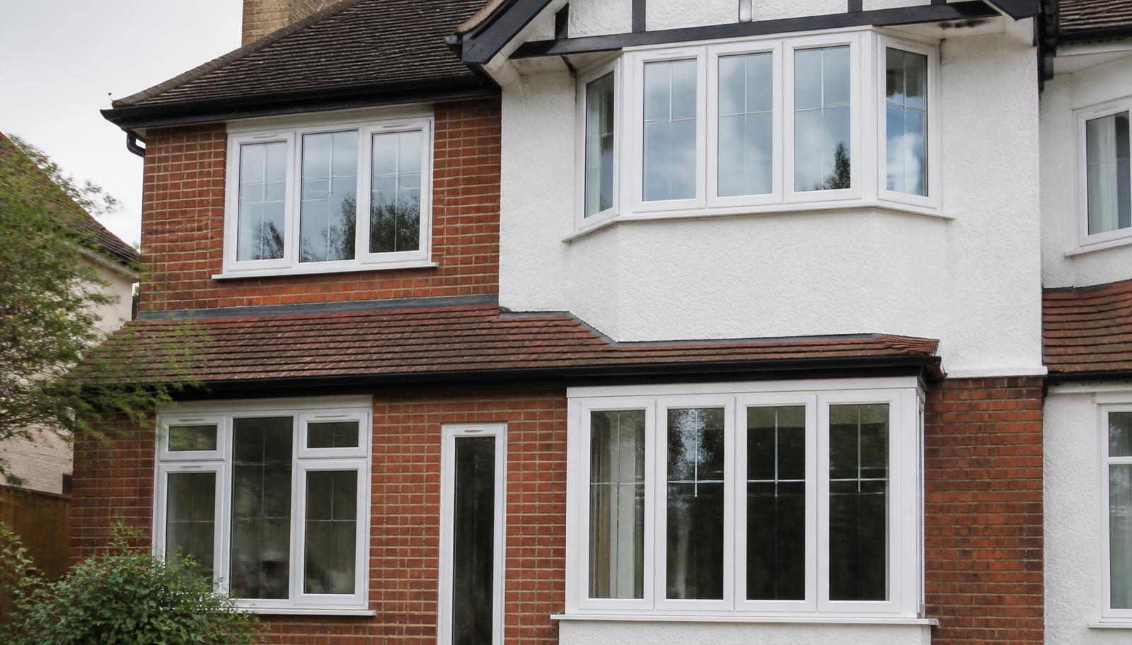 White uPVC casement and bay windows fitted to a 1930s British semi-detached house